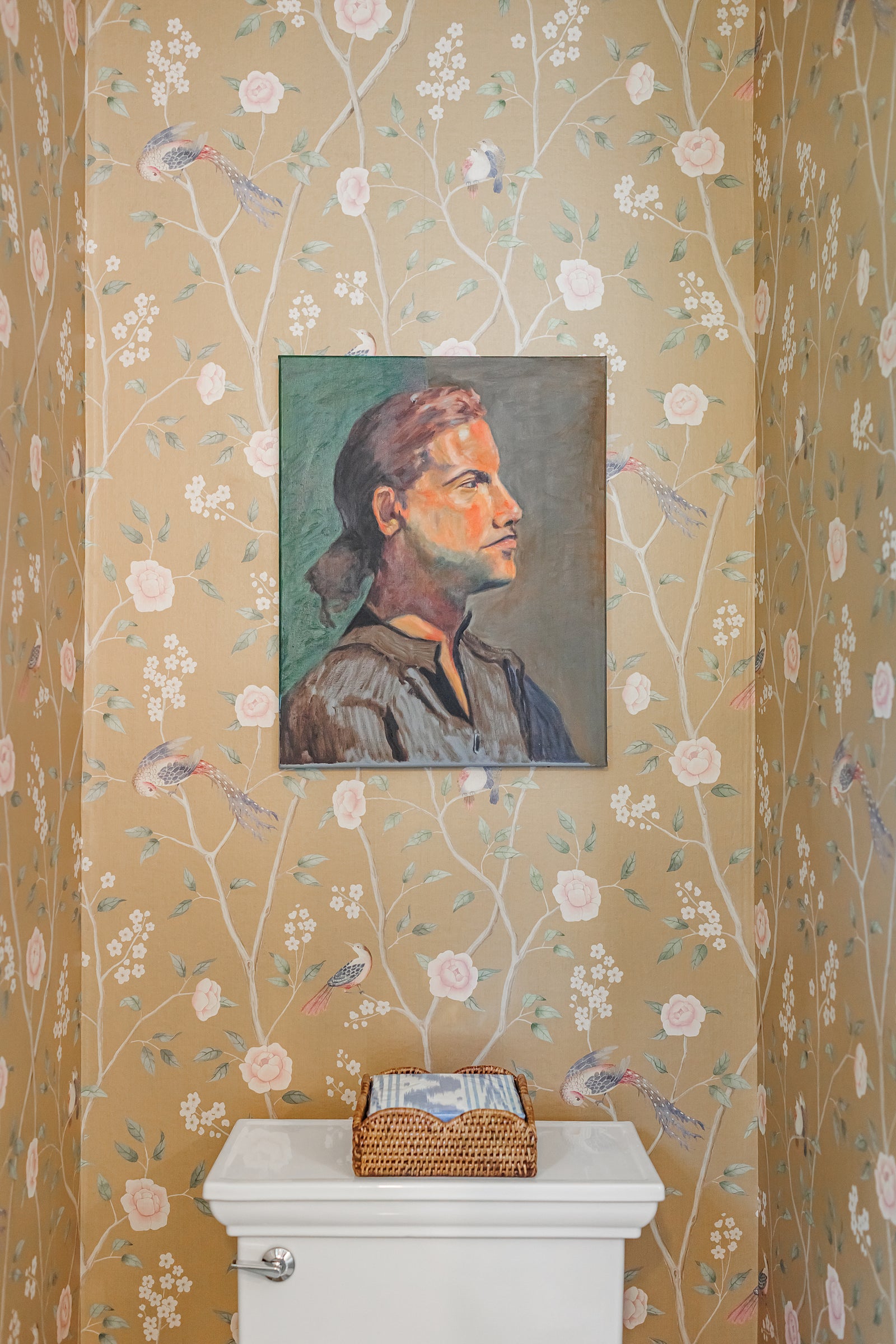 Powder room with chinoiserie wallpaper and a painted portrait