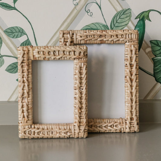 4x6 and 5x7 wicker picture frames on a surface with a decorative wall in the background