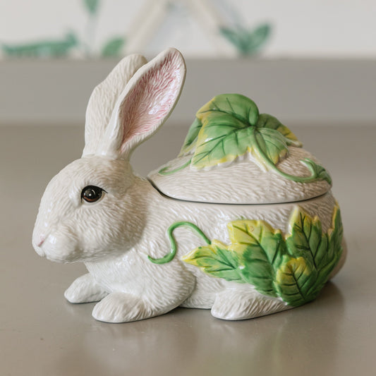 Decorative rabbit-shaped container with a lid on a neutral background