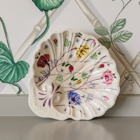 Decorative shell with floral patterns on a surface with a decorative background