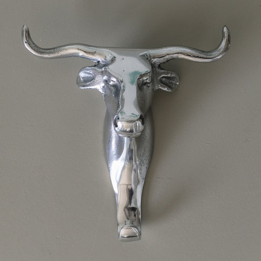 Metallic bull head wall decoration on a plain background