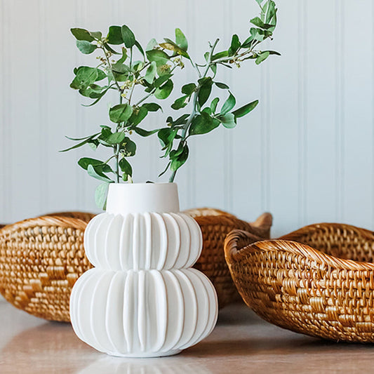 white pleated vase with rattan bowls oakstreet shoppe